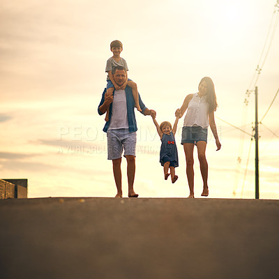 Buy stock photo Shot of a young family taking a walk down the road outside