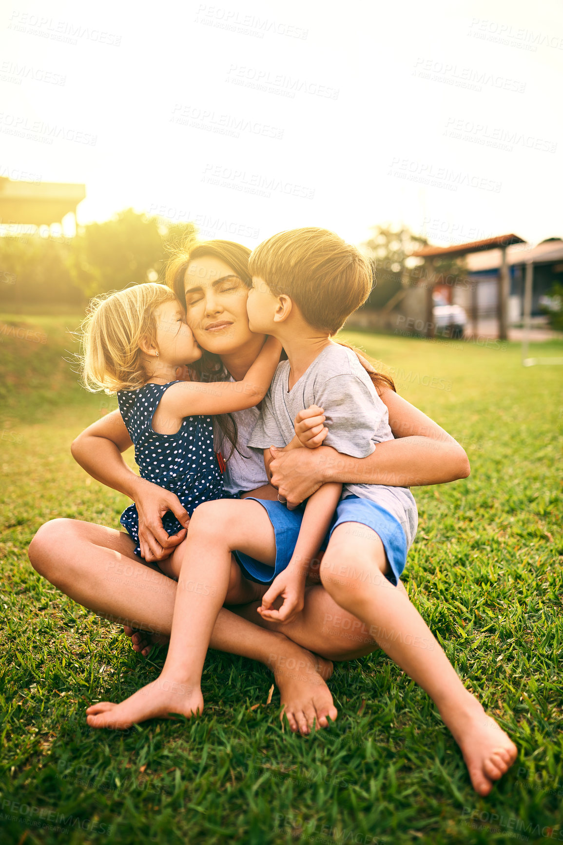 Buy stock photo Shot of a mother bonding with her two adorable little children outdoors
