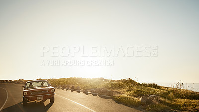 Buy stock photo Shot of a young couple enjoying a road trip together