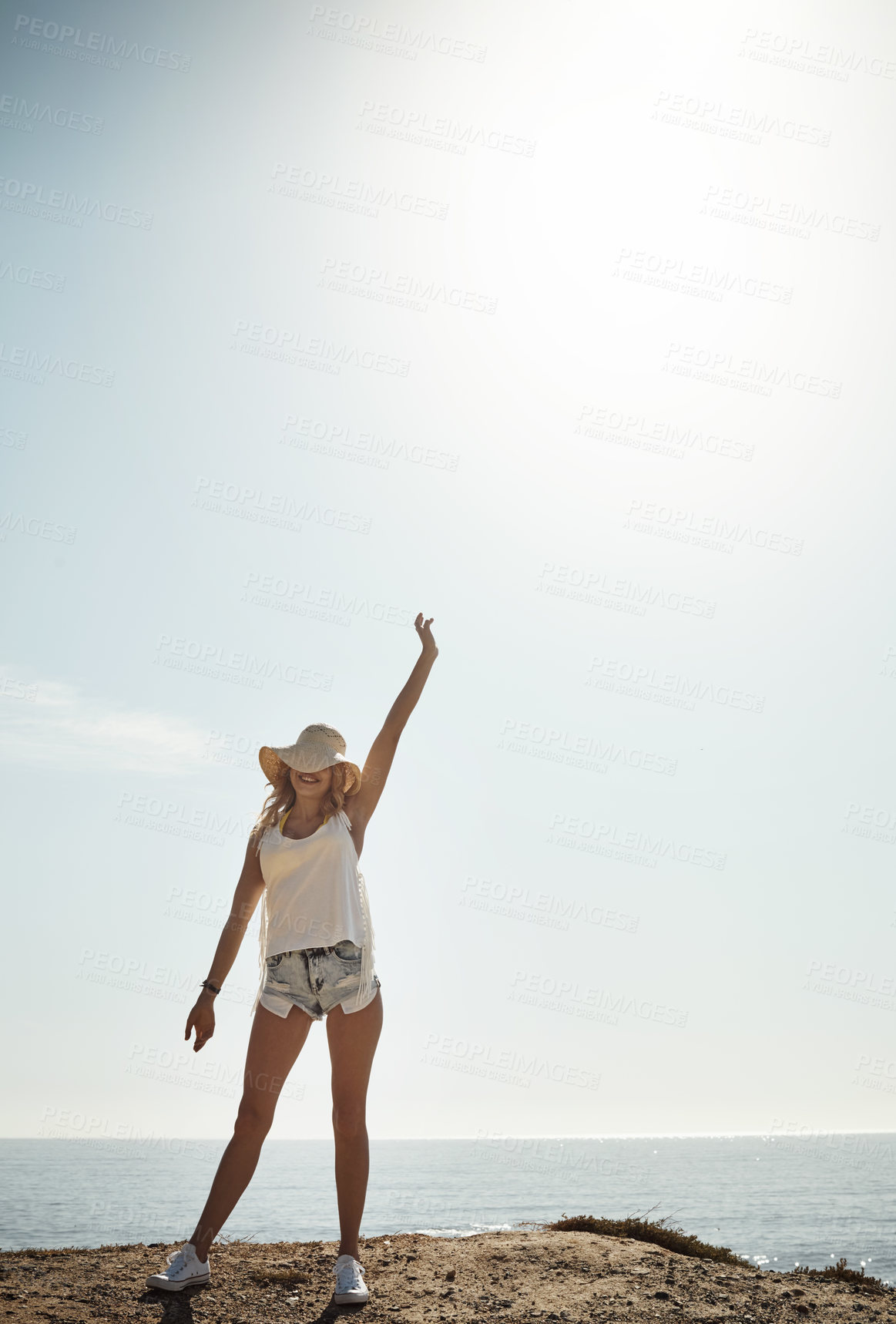 Buy stock photo Shot of an attractive young woman enjoying her day on the beach