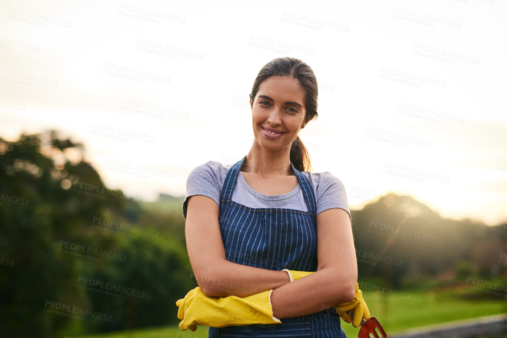 Buy stock photo Cropped portrait of an attractive young woman standing with her arms folded on her farm