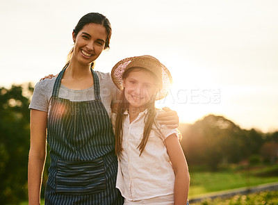 Buy stock photo Cropped portrait of an attractive young woman and her daughter standing on their family farm