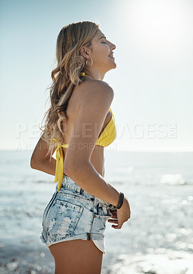 Buy stock photo Shot of an attractive young woman enjoying her day on the beach