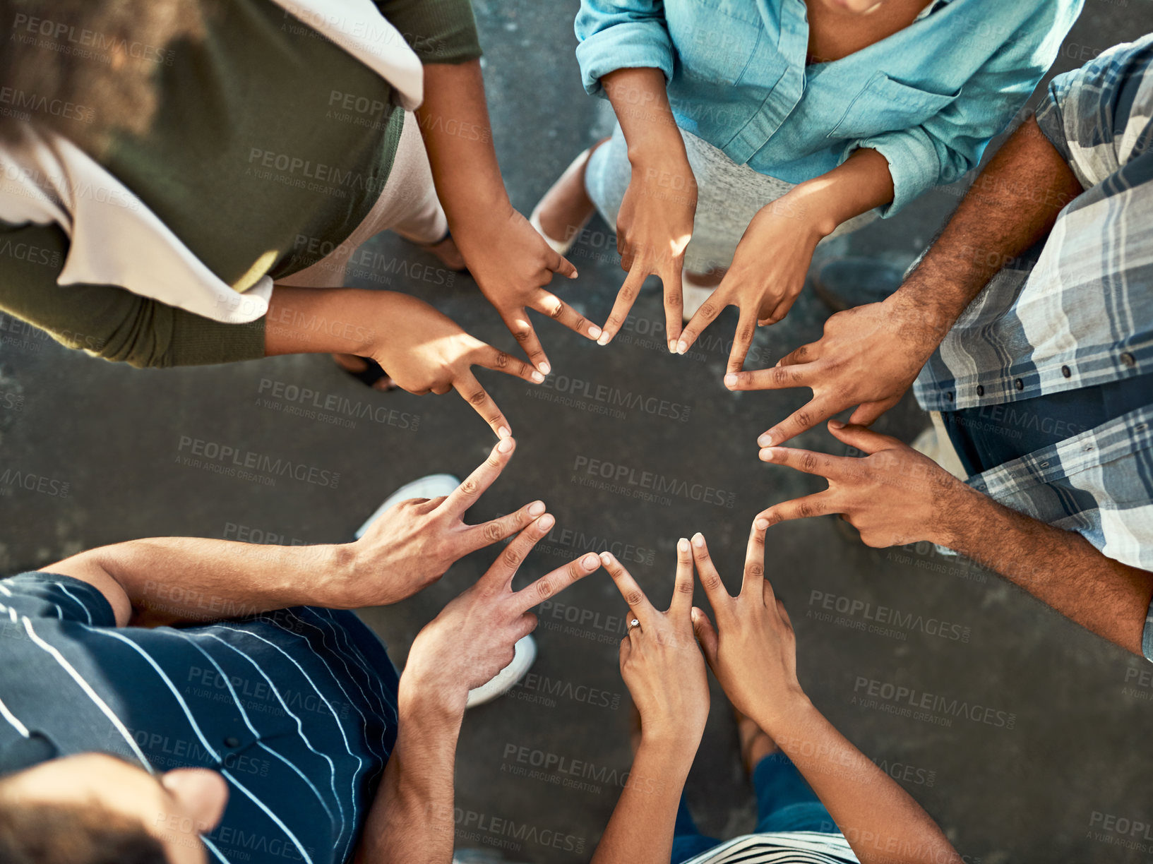 Buy stock photo High angle shot of an unrecognizable group of work colleagues forming an unique huddle with their fingers while standing in the office at work