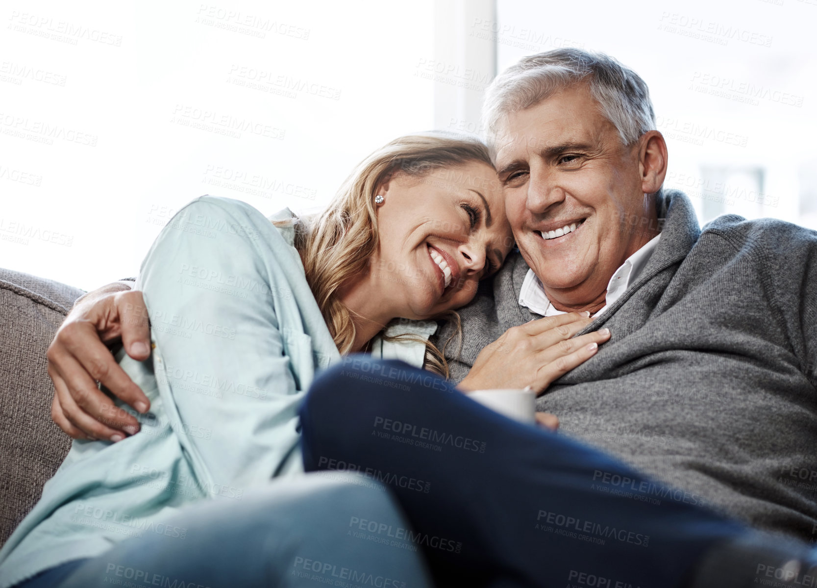 Buy stock photo Shot of a mature couple relaxing on the sofa together at home