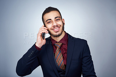 Buy stock photo Studio shot of a handsome young businessman posing against a grey background