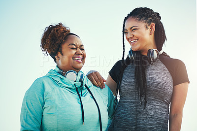 Buy stock photo Shot of two sporty young women standing together outdoors