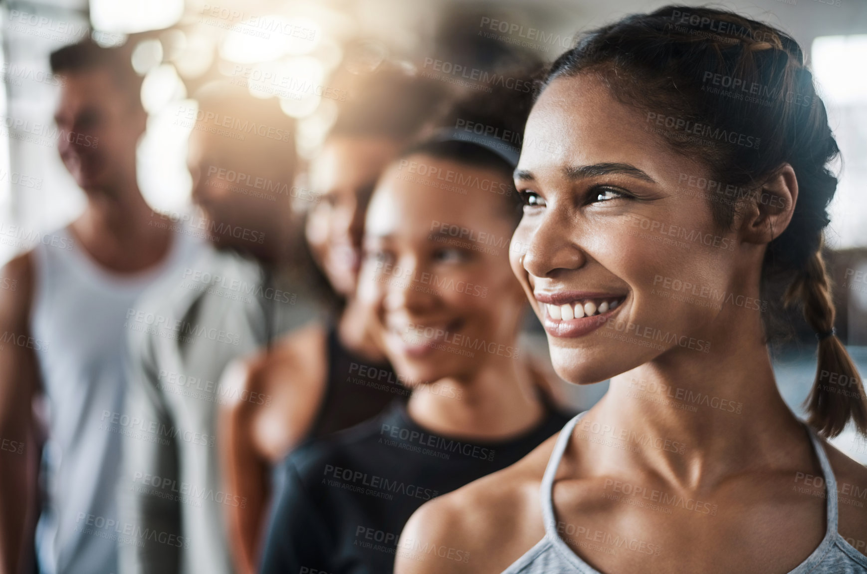 Buy stock photo Shot of a group of young people standing together in a line at the gym