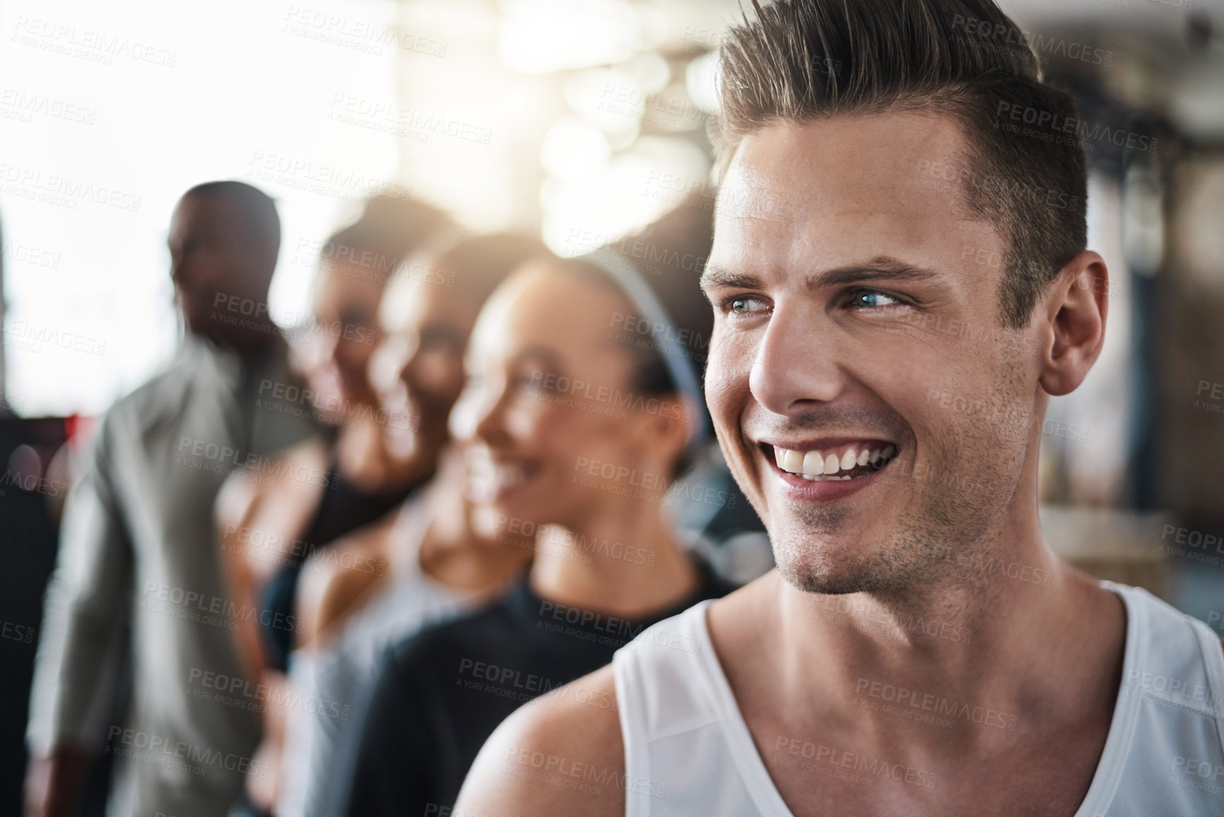 Buy stock photo Shot of a group of young people standing together in a line at the gym