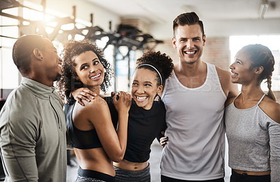 Buy stock photo Shot of a group of happy young people working out together in a gym