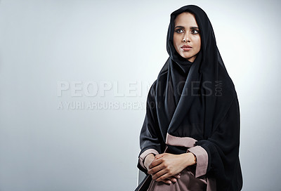 Buy stock photo Cropped shot of an attractive young businesswoman sitting in the studio against a grey background