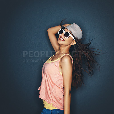 Buy stock photo Studio shot of an attractive and fun loving young woman posing against a dark background