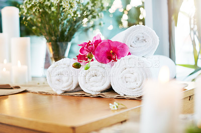 Buy stock photo Still life shot of flowers and towels on a table in a spa