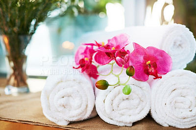 Buy stock photo Still life shot of flowers and towels on a table in a spa