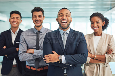 Buy stock photo Portrait of a group of cheerful young businesspeople standing with their arms folded in the office during the day