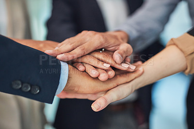 Buy stock photo Closeup of a group of unrecognizable businesspeople forming a huddle with their hands while standing in the office during the day