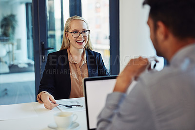 Buy stock photo Shot of a young businessman and businesswoman having a discussion in the boardroom of a modern office