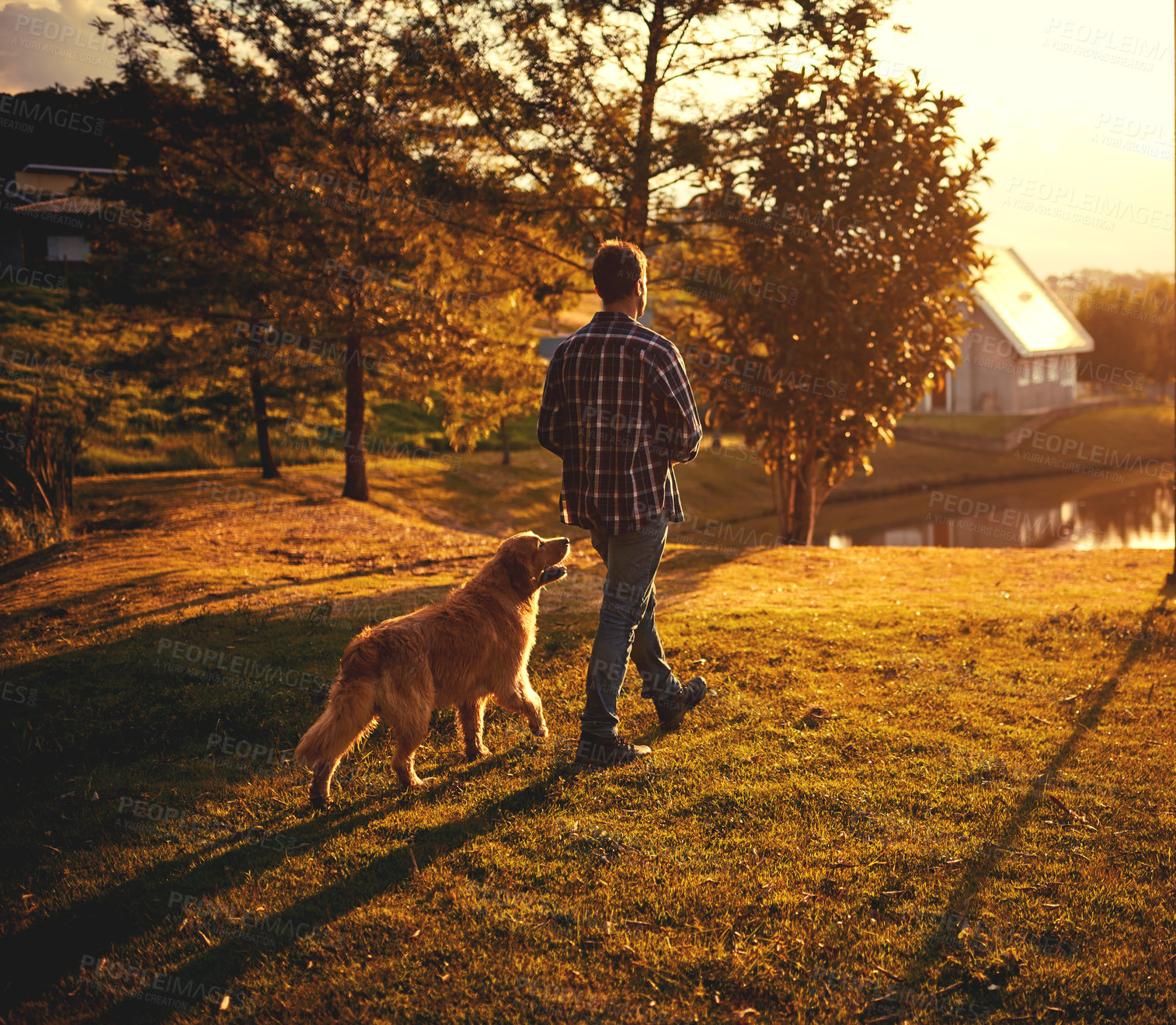 Buy stock photo Full length shot of a handsome young man walking with his dog around the park