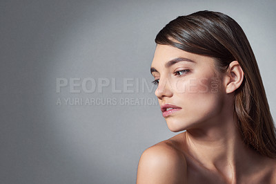 Buy stock photo Studio shot of a beautiful young woman posing against a gray background 