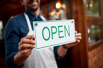 Buy stock photo Shot of a unrecognizable business owner holding up a sign saying 