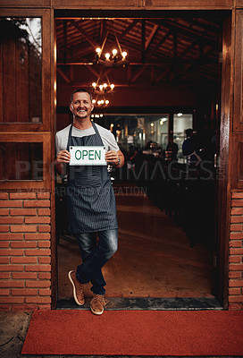 Buy stock photo Portrait of a cheerful middle aged business owner holding up a sign saying 
