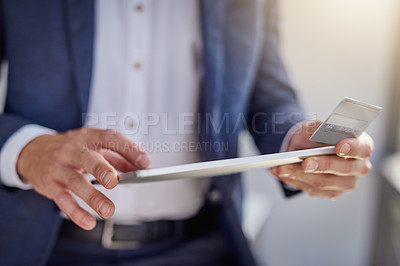 Buy stock photo Cropped shot of an unrecognizable businessman using a digital tablet and credit card in a modern office