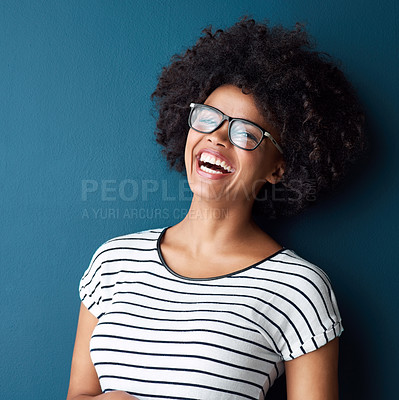Buy stock photo Portrait, funny and woman with glasses, afro and confident girl on blue studio background. Face, person and model with eyewear, cheerful and laughing for joke, humor and happiness with smile or gen z