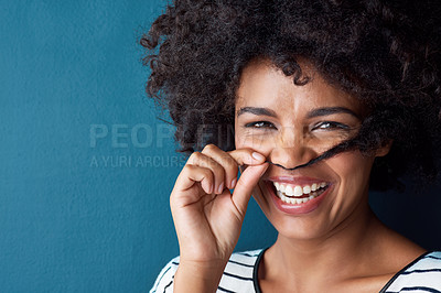 Buy stock photo Girl, mustache and pull curly hair in studio portrait for growth, results and funny smile by blue background. African person, woman and mock up space with texture, playful and cosmetics for afro