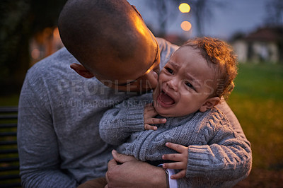 Buy stock photo Shot of a father comforting his crying son outdoors