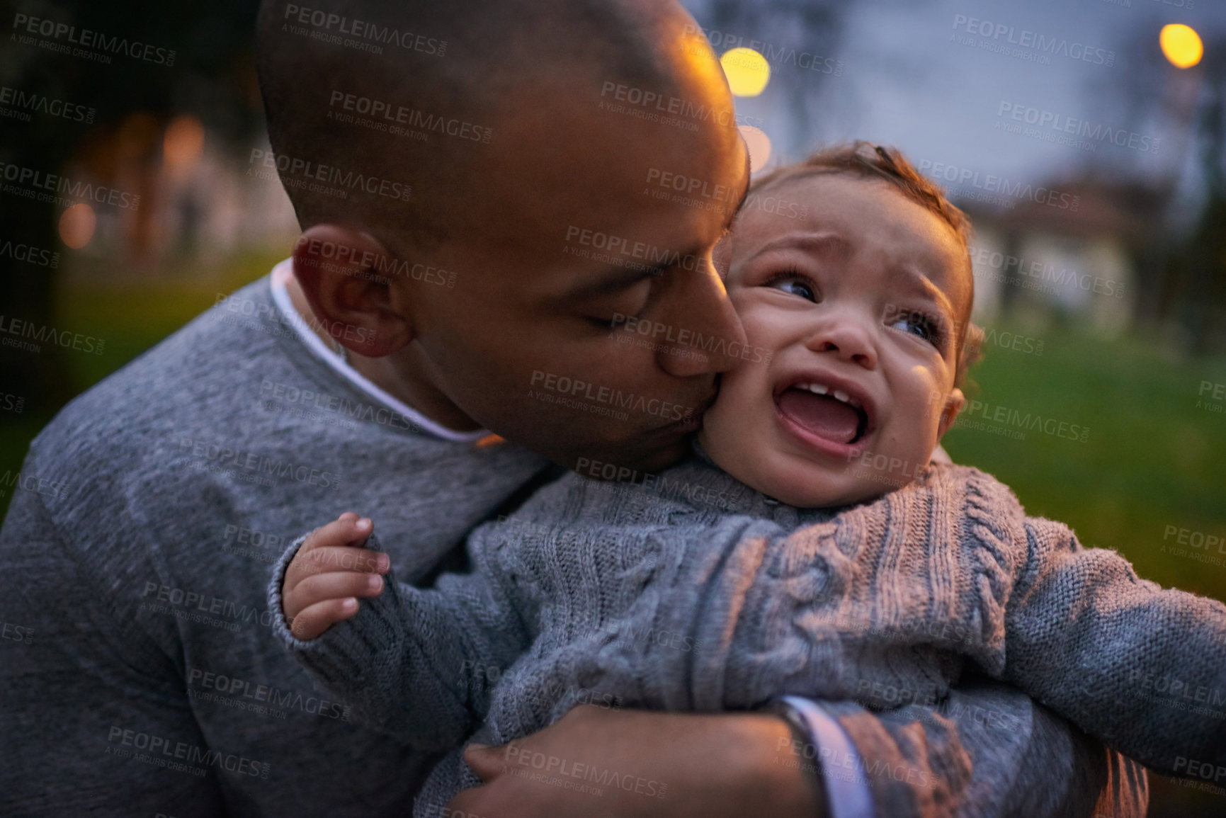 Buy stock photo Shot of a father comforting his crying son outdoors