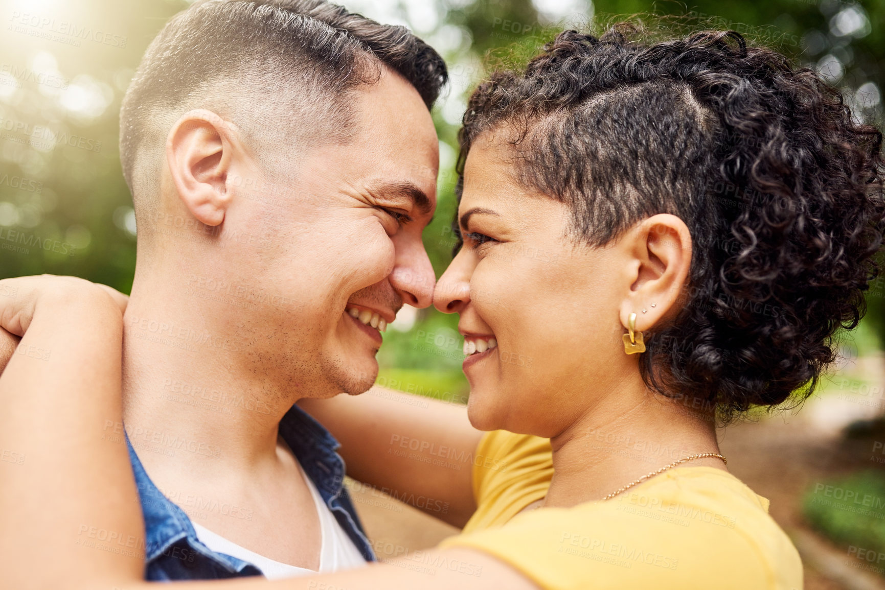 Buy stock photo Couple, hug and eye contact with smile in park, summer and love with profile in sunshine by trees. Man, woman and happy with embrace, care and connection with bonding, trust and loyalty in Mexico