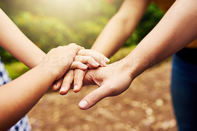 Buy stock photo Cropped shot of an unrecognizable woman and her daughter with their hands in a pile while standing outside in the park