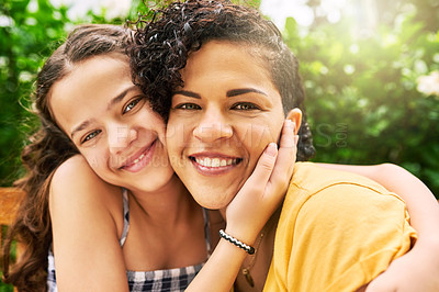 Buy stock photo Cropped portrait of a young woman and her adorable little girl sitting on a bench in the park