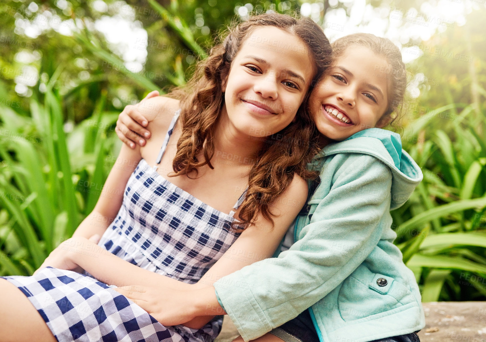 Buy stock photo Cropped portrait of two young sisters enjoying their day in the park
