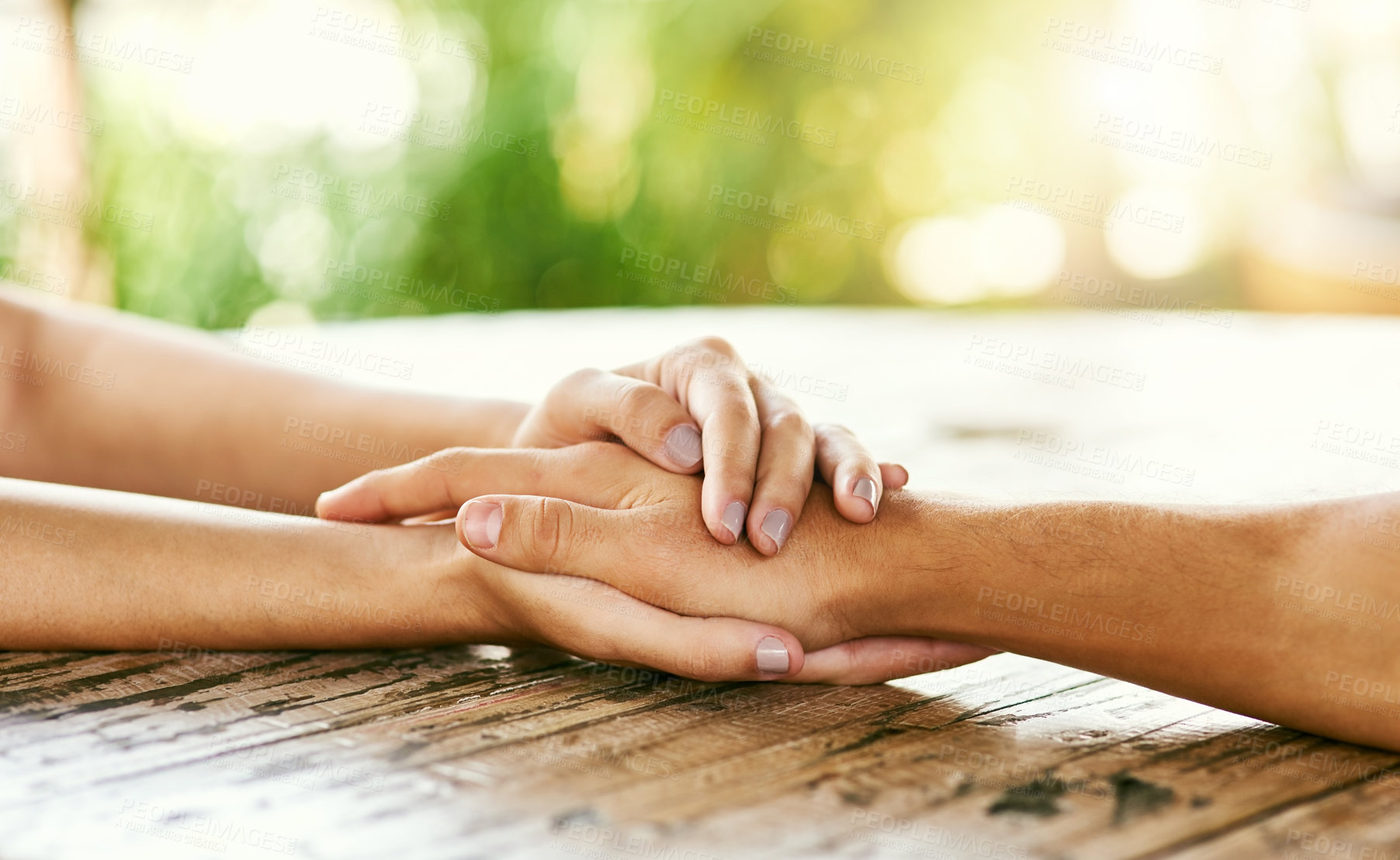 Buy stock photo Closeup shot of a man and woman holding hands in comfort on a table