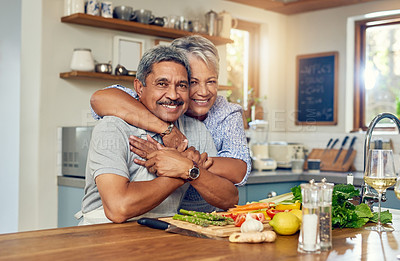 Buy stock photo Love, hug and cooking, portrait of old couple in kitchen with healthy food, happiness and diet together in home. Smile, senior man and woman in house for meal prep, embrace and wellness in retirement