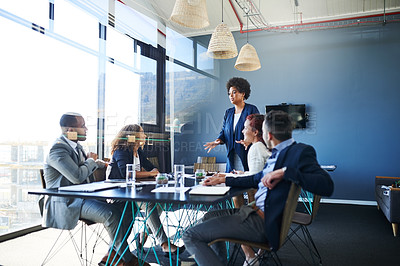 Buy stock photo Shot of a group of businesspeople having a meeting in the boardroom