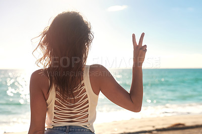 Buy stock photo Rearview shot of an unrecognizable woman on the beach