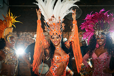 Buy stock photo Cropped shot of three beautiful samba dancers performing in a carnival with their band