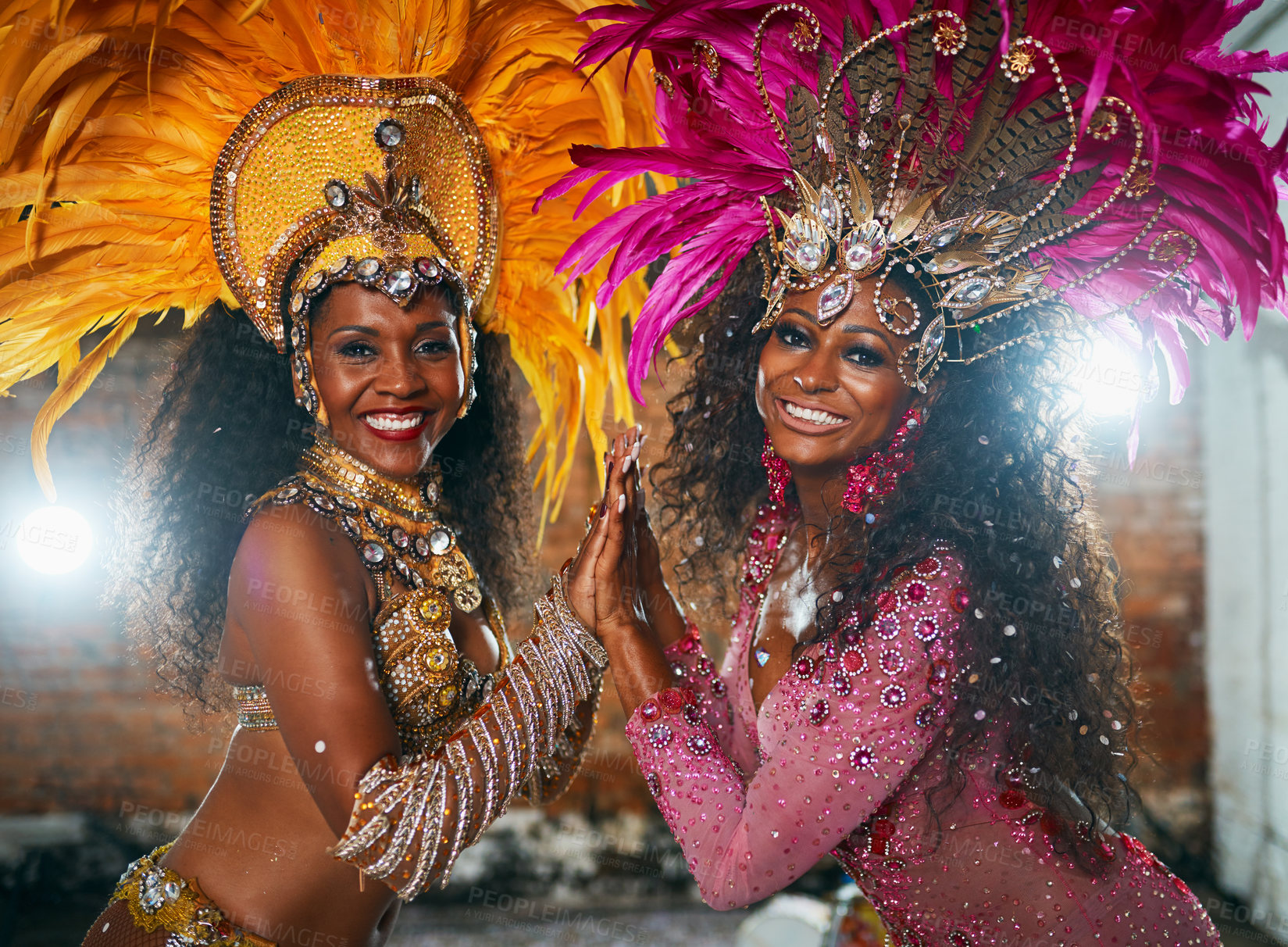 Buy stock photo Cropped portrait of two beautiful samba dancers performing in a carnival with their band