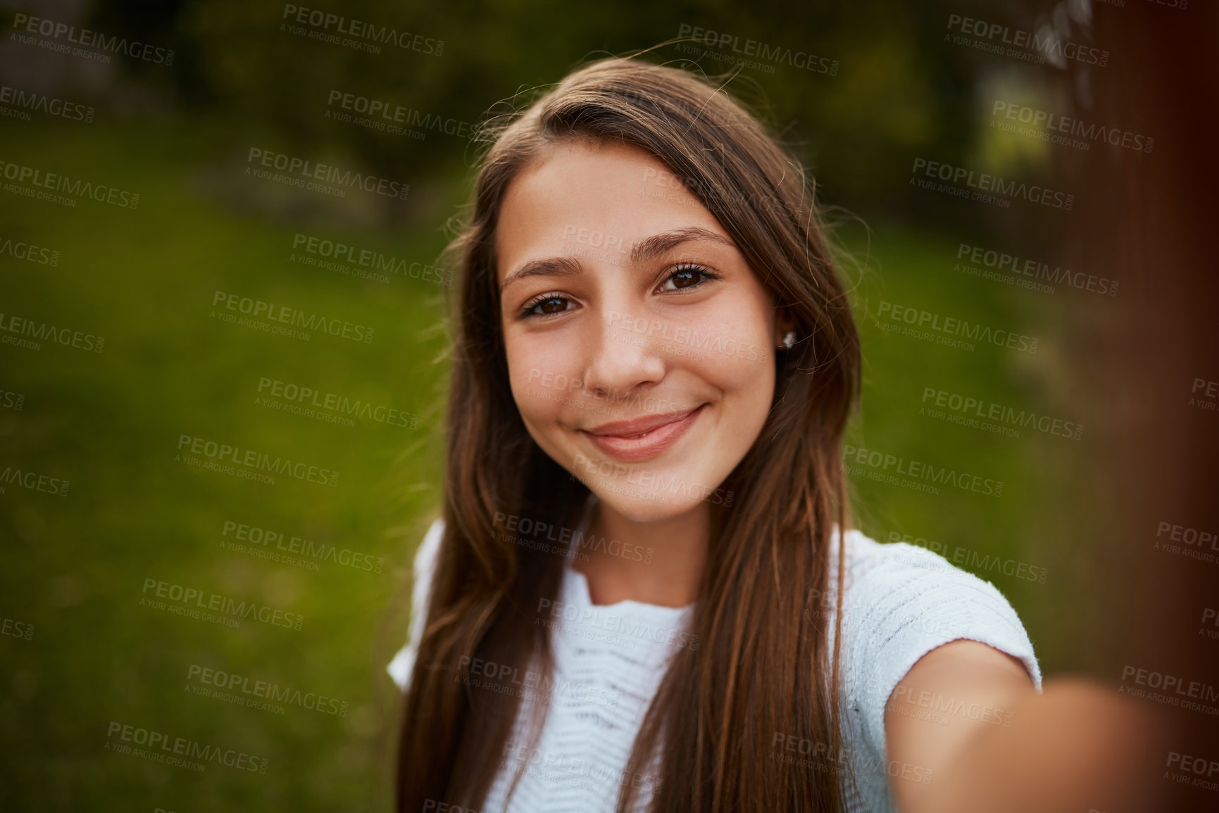 Buy stock photo Cropped portrait of a young girl taking selfies in the park