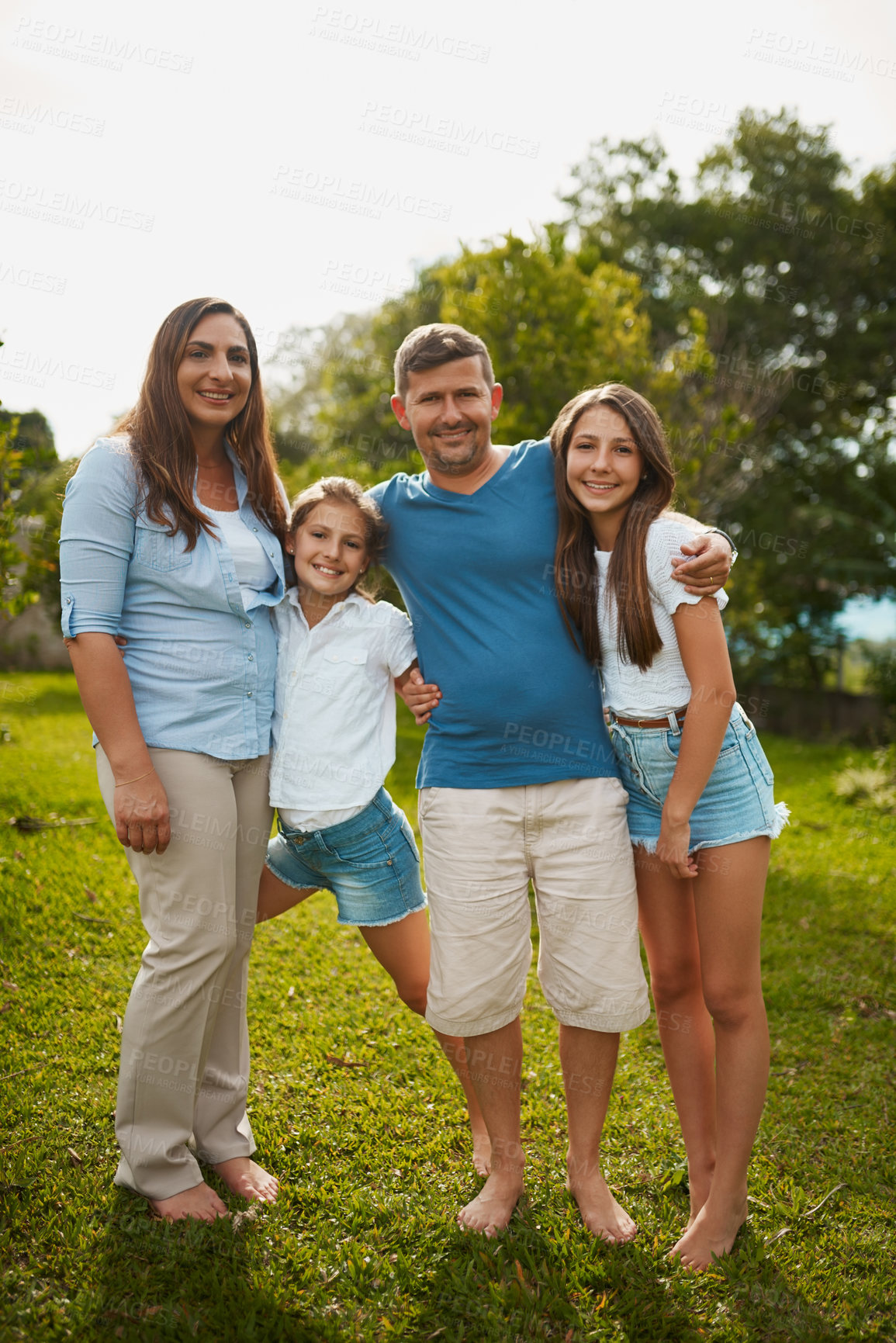 Buy stock photo Full length portrait of a young family of four standing outside