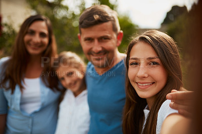 Buy stock photo Cropped portrait of a young family of four standing outside