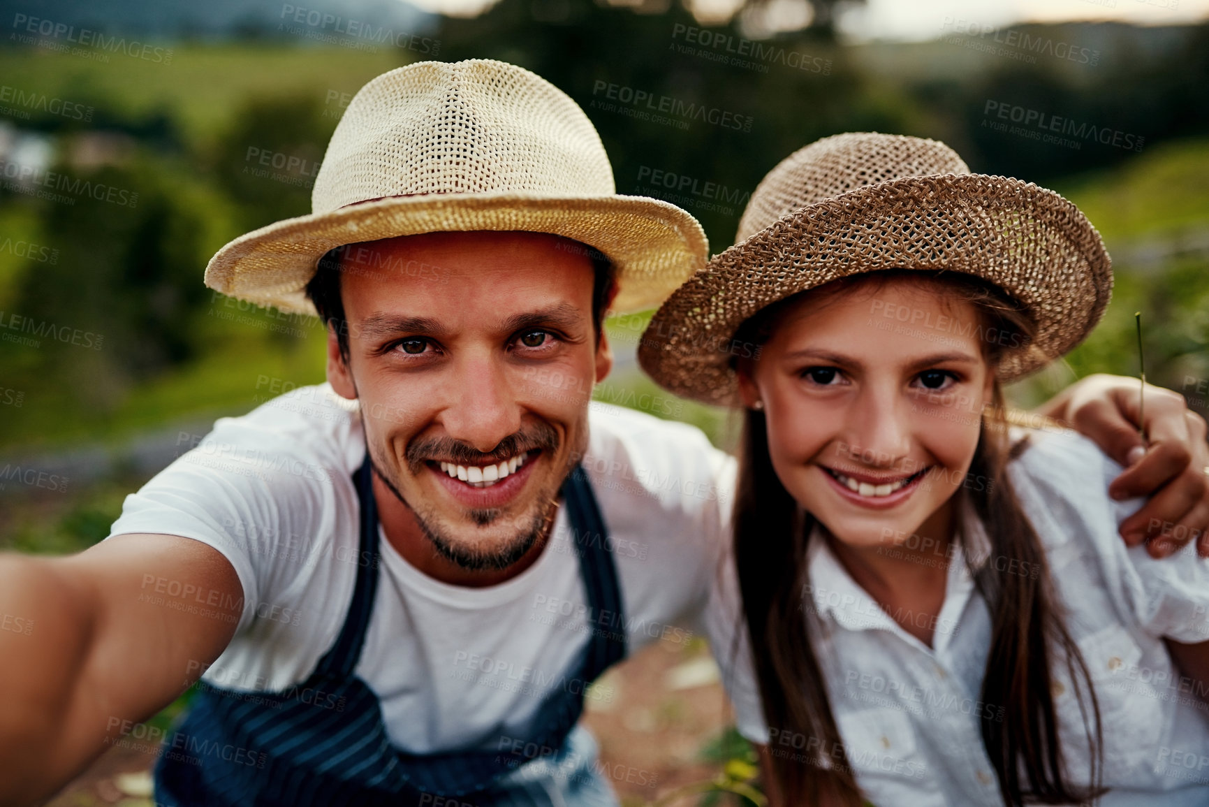 Buy stock photo Cropped portrait of a handsome man and his young daughter taking selfies while working on their farm