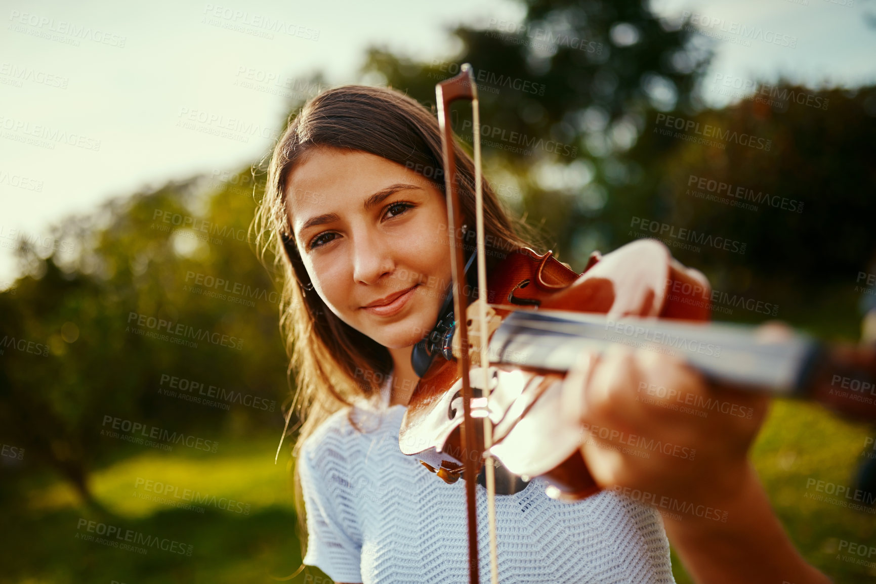 Buy stock photo Girl, violin and portrait in nature for music, talent and entertainment for event. Musician, string instrument and smile on grass for art, rehearsal and practice for creativity with skill development