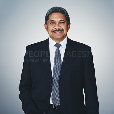 Buy stock photo Studio portrait of a mature businessman posing against a grey background