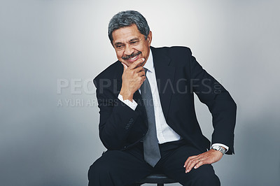Buy stock photo Studio shot of a mature businessman looking thoughtful against a grey background