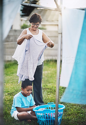 Buy stock photo Backyard, grandmother and grandchild with laundry, help and chore with summer and bonding together. Family, senior woman and boy with clean clothes and activity with washing, outdoor and home