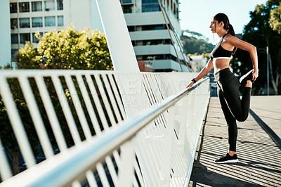 Buy stock photo Woman, fitness and stretching with leg in city preparation for workout, exercise or outdoor training. Young runner, active or female person in sportswear, warm up or getting ready for cardio in town