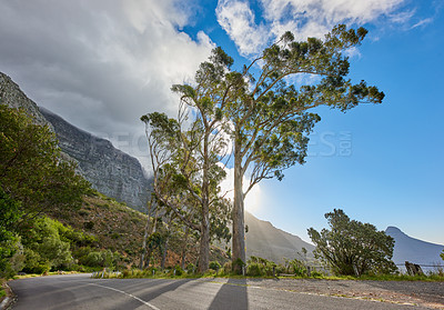 Buy stock photo Mountains, road and trees with nature, tourism and earth day with environment, holiday and clouds. Empty, street and plants with blue sky, adventure and travel with vacation, countryside and Miami